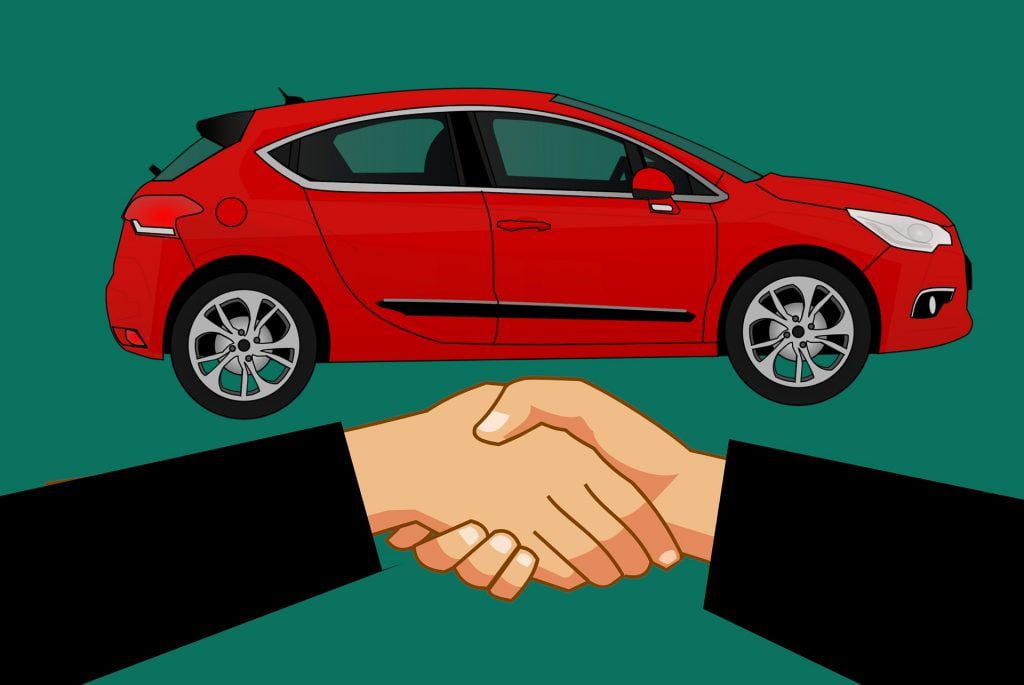 Shaking hands in front of car